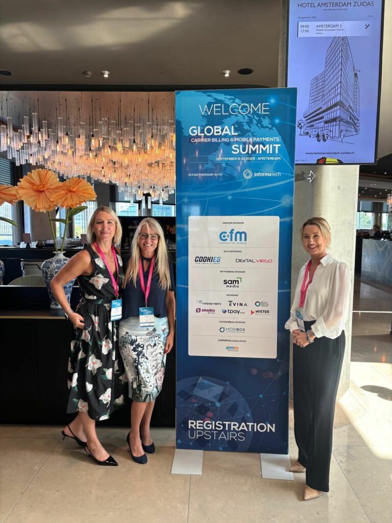 UK Panel members from AIMM, EE and DCB stand by the Global Carrier Billing Summit banner ahead of the talks.